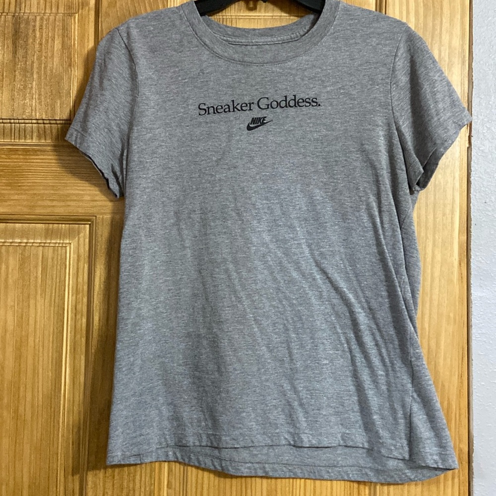 Gray Nike tee says “sneaker goddess” across the chest